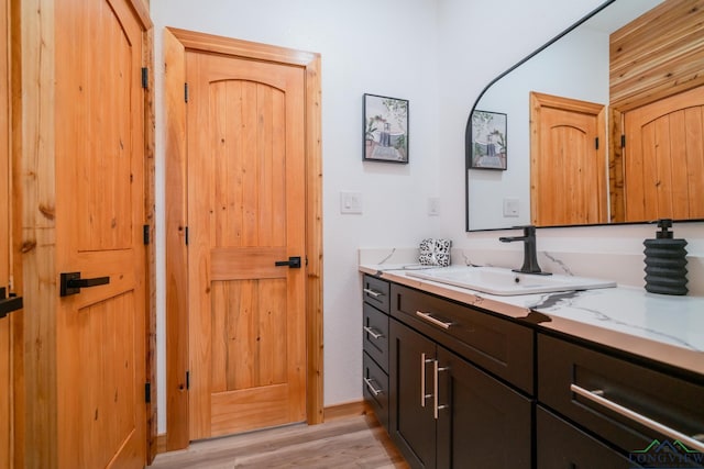 bathroom with vanity and hardwood / wood-style flooring