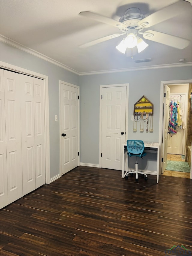 505 Timberdale, Kilgore, TX 75662 - unfurnished bedroom with dark wood-style flooring, crown molding, a closet, ceiling fan, and baseboards