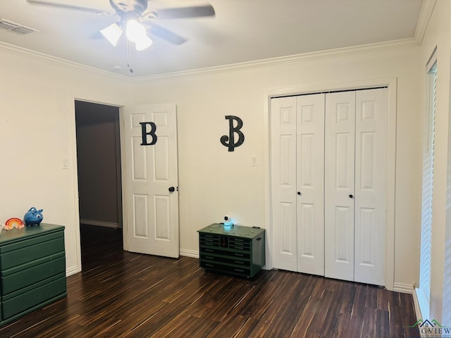 505 Timberdale, Kilgore, TX 75662 - bedroom with dark wood-style flooring, ornamental molding, a closet, ceiling fan, and baseboards
