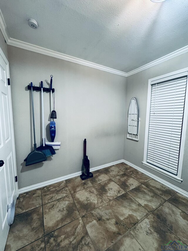 505 Timberdale, Kilgore, TX 75662 - unfurnished room featuring crown molding, a smoke detector, a textured ceiling, and baseboards