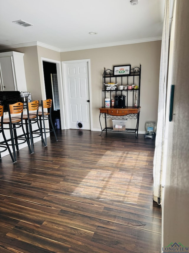 505 Timberdale, Kilgore, TX 75662 - dining area with crown molding, dark wood-style flooring, and baseboards