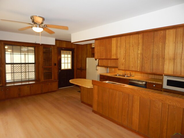 2231 W Stae Highway 154, Gilmer, TX 75644 - kitchen featuring white appliances, brown cabinets, and a sink