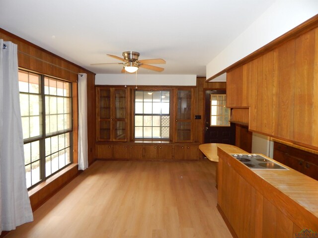 2231 W Stae Highway 154, Gilmer, TX 75644 - kitchen with brown cabinetry, light wood-type flooring, and a healthy amount of sunlight