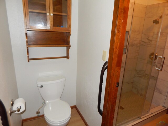 2231 W Stae Highway 154, Gilmer, TX 75644 - bathroom featuring toilet, a stall shower, and baseboards