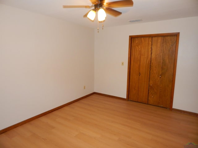 2231 W Stae Highway 154, Gilmer, TX 75644 - unfurnished bedroom with visible vents, light wood-style flooring, and baseboards