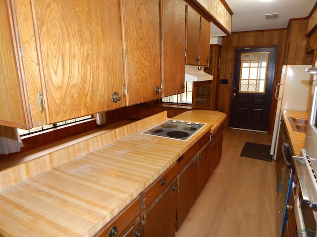 2231 W Stae Highway 154, Gilmer, TX 75644 - kitchen with electric stovetop, wooden walls, under cabinet range hood, wood finished floors, and visible vents