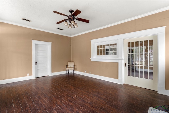 empty room featuring ornamental molding, dark hardwood / wood-style floors, and ceiling fan