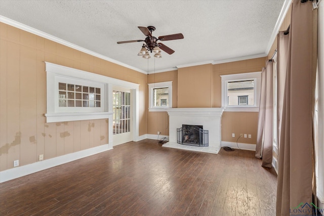 unfurnished living room featuring hardwood / wood-style flooring, ornamental molding, ceiling fan, and a textured ceiling