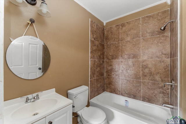 full bathroom featuring tiled shower / bath, vanity, toilet, and ornamental molding