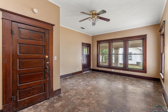 foyer entrance featuring crown molding and ceiling fan