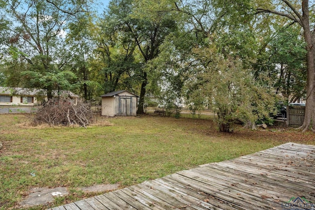 view of yard with a deck and a storage unit