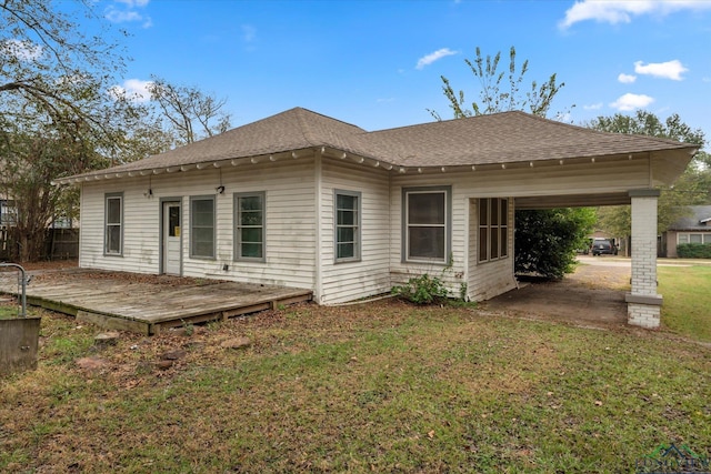 back of property featuring a wooden deck and a lawn