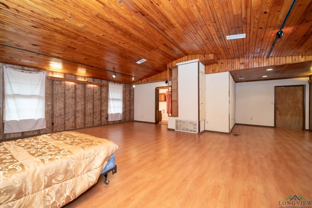 unfurnished bedroom featuring lofted ceiling, wooden ceiling, and light hardwood / wood-style flooring