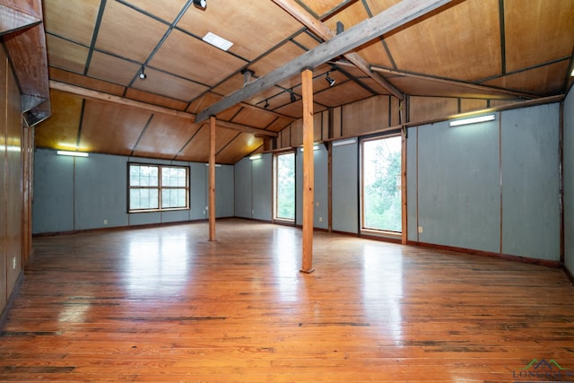 basement with light hardwood / wood-style flooring and wooden ceiling