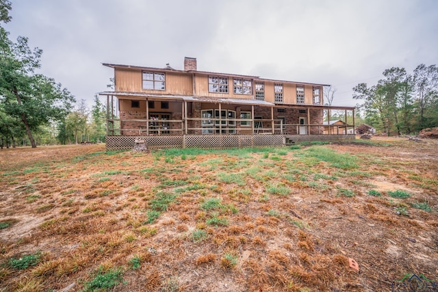 back of property featuring a porch