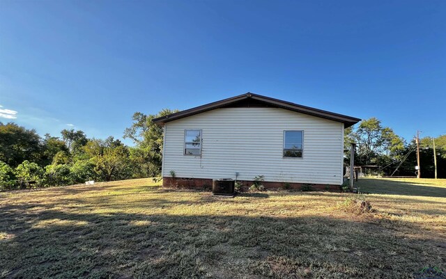 227 County Road 2997, Hughes Springs, TX 75656 - view of property exterior featuring a yard and central AC