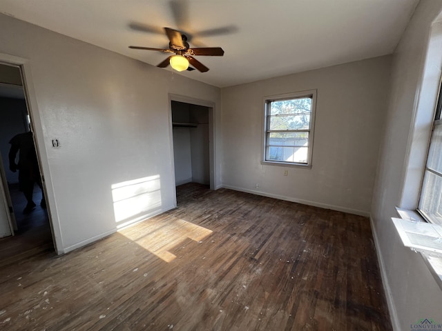 unfurnished bedroom with ceiling fan, dark hardwood / wood-style floors, and a closet