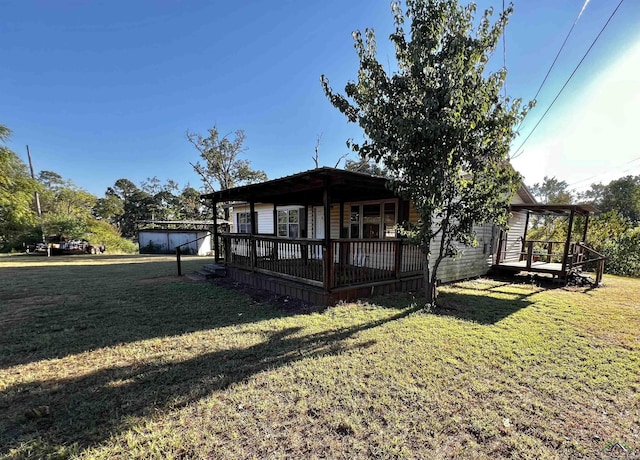 view of front of property featuring a front lawn and a deck