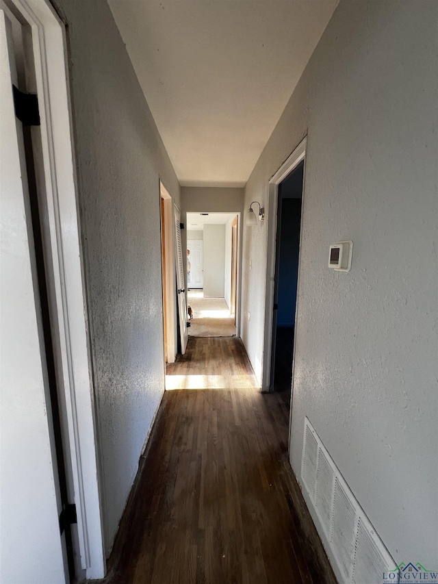 hallway featuring dark hardwood / wood-style flooring