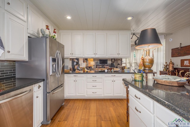 2003 Broadway Blvd, Kilgore, TX 75662 - kitchen featuring appliances with stainless steel finishes, white cabinetry, light wood-style floors, recessed lighting, and decorative backsplash