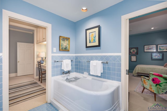 2003 Broadway Blvd, Kilgore, TX 75662 - ensuite bathroom with a bath, tile walls, wainscoting, and recessed lighting