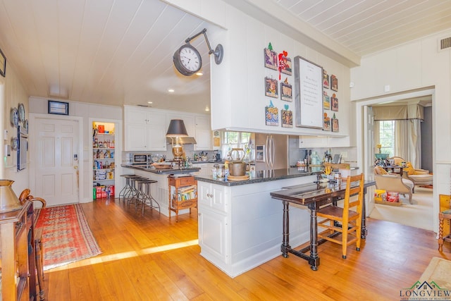 2003 Broadway Blvd, Kilgore, TX 75662 - kitchen with stainless steel fridge, a peninsula, healthy amount of natural light, and wood ceiling
