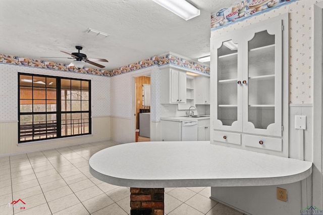 bathroom with wallpapered walls, washer / dryer, a wainscoted wall, ceiling fan, and a textured ceiling