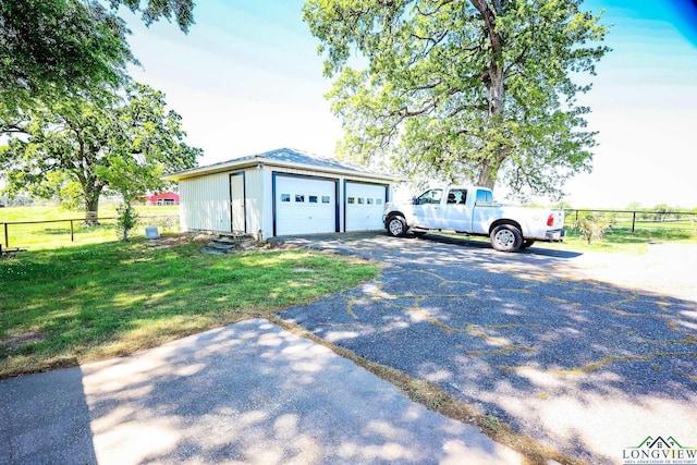 garage featuring a lawn