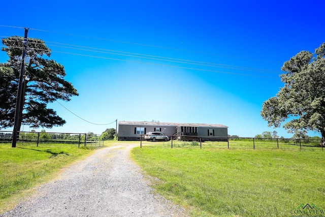 manufactured / mobile home featuring a front lawn and a rural view