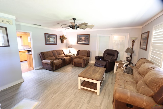 living room with ceiling fan, light hardwood / wood-style floors, and ornamental molding