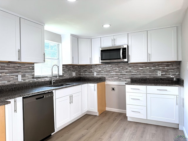 kitchen with white cabinetry, sink, and dishwasher