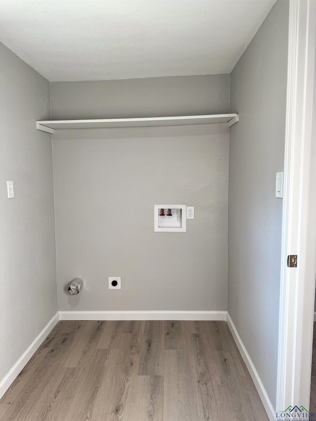 laundry area with hookup for a washing machine, hookup for an electric dryer, and light wood-type flooring