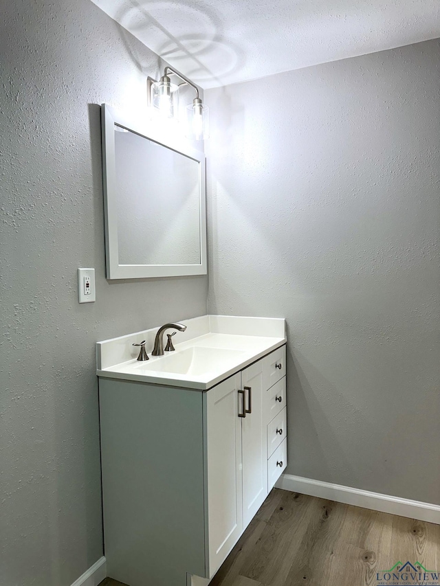 bathroom with vanity and wood-type flooring