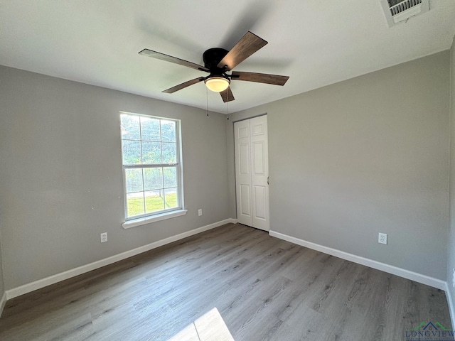 spare room with ceiling fan and light hardwood / wood-style flooring