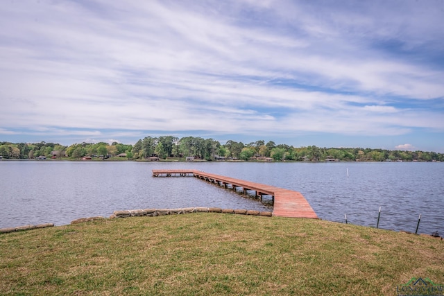 dock area with a water view and a lawn