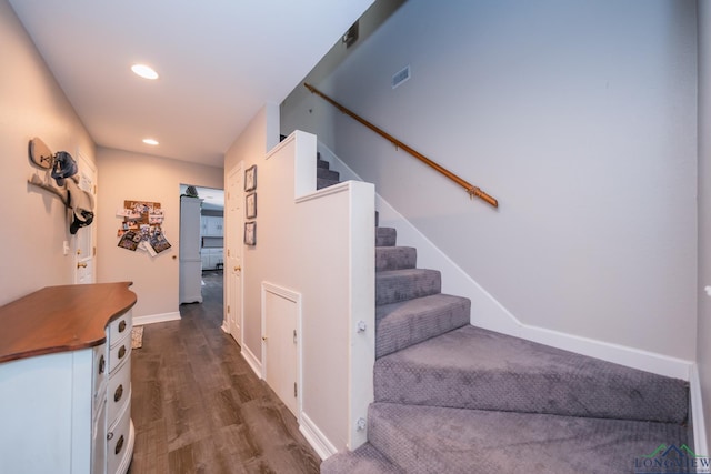 stairway featuring wood-type flooring