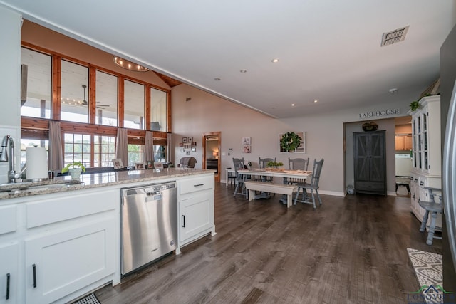 kitchen featuring dishwasher, light stone countertops, white cabinetry, and sink