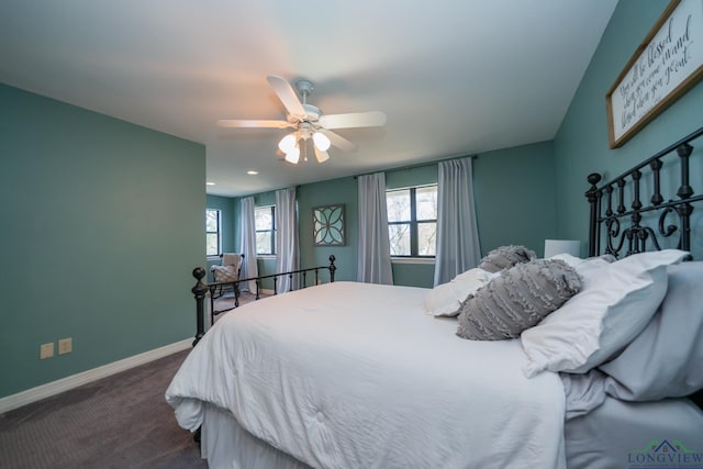 bedroom with dark colored carpet and ceiling fan