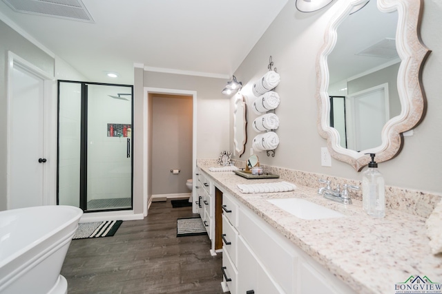 full bathroom featuring hardwood / wood-style floors, vanity, toilet, and independent shower and bath