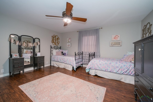 bedroom with ceiling fan and dark hardwood / wood-style flooring