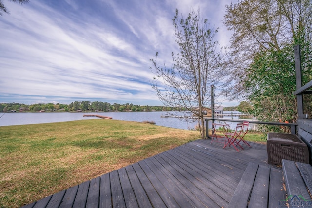 wooden deck with a yard and a water view