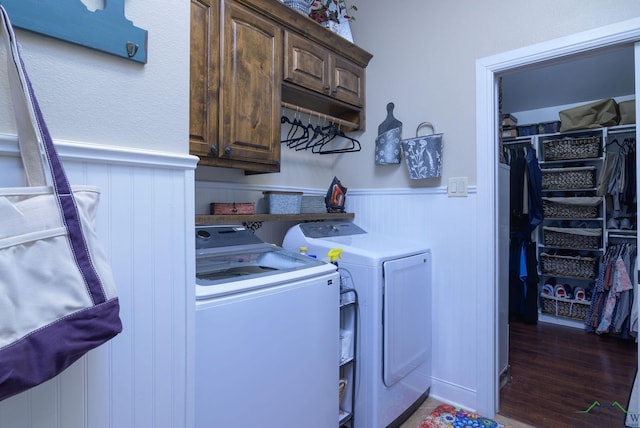 905 Woodridge Cir, Longview, TX 75601 - washroom featuring washing machine and dryer, cabinet space, wainscoting, wood finished floors, and a decorative wall