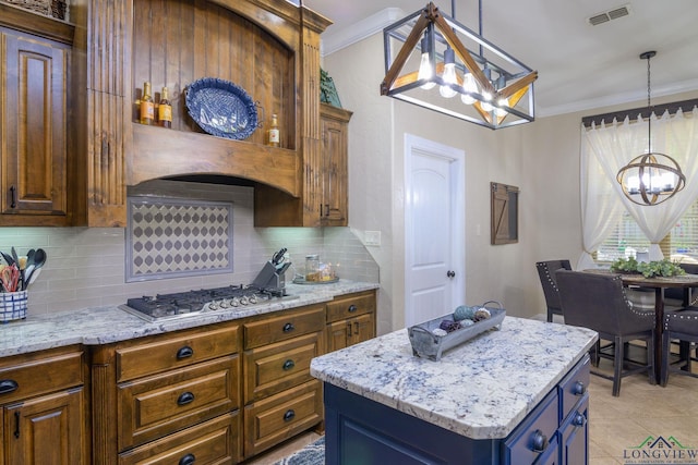 905 Woodridge Cir, Longview, TX 75601 - kitchen featuring a chandelier, stainless steel gas cooktop, ornamental molding, decorative backsplash, and light stone countertops