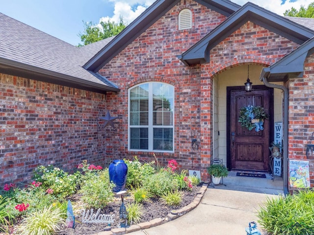 905 Woodridge Cir, Longview, TX 75601 - view of exterior entry with brick siding and roof with shingles