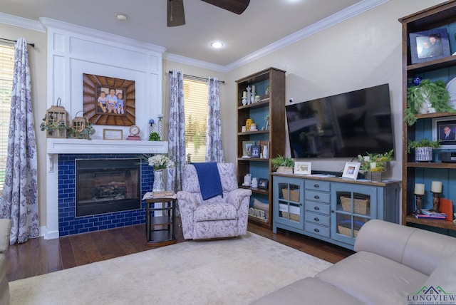 905 Woodridge Cir, Longview, TX 75601 - living room featuring wood finished floors, crown molding, a ceiling fan, and a tiled fireplace