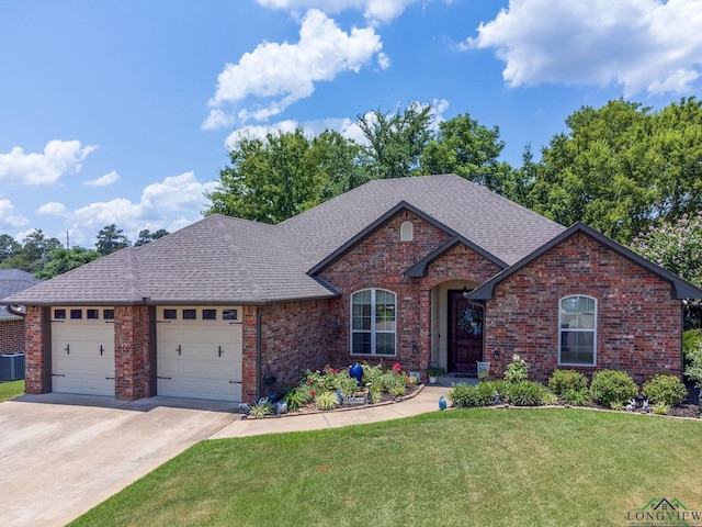 905 Woodridge Cir, Longview, TX 75601 - view of front of property with brick siding, roof with shingles, a garage, a front yard, and cooling unit