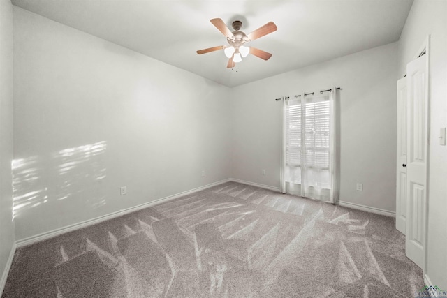 spare room with ceiling fan and light colored carpet