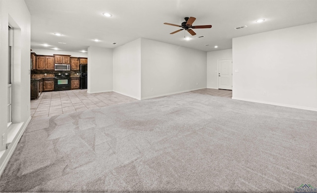 unfurnished living room with light carpet and ceiling fan