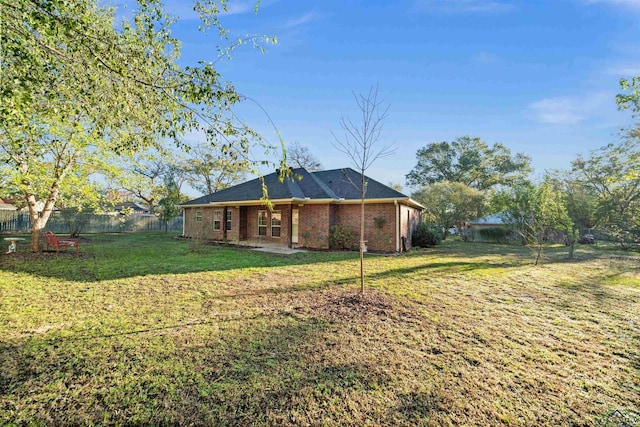 rear view of property with a yard