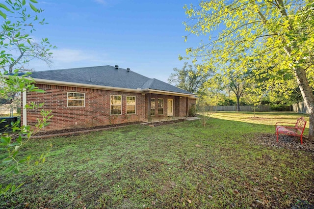 rear view of house with a lawn